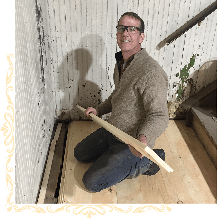 Man kneeling with wooden planks