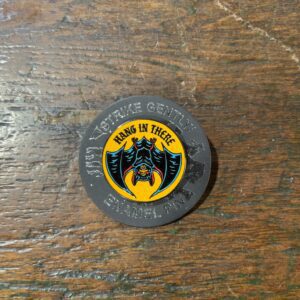 Circular patch featuring bat and text design