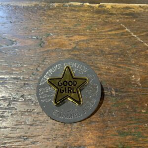 Gold star badge on table surface