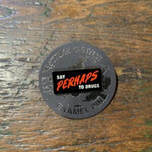Enamel pin on wooden surface