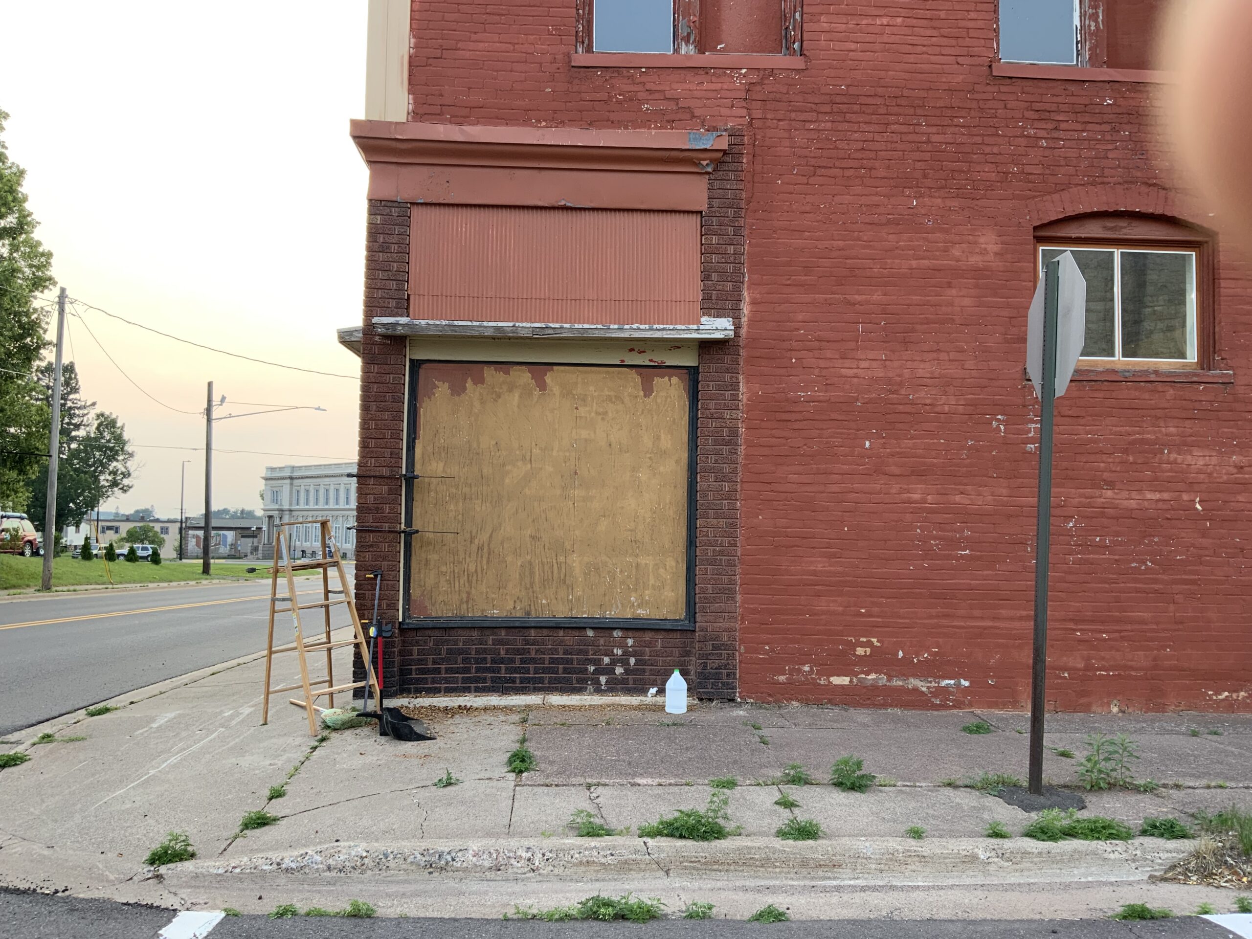 Urban street scene with boarded window