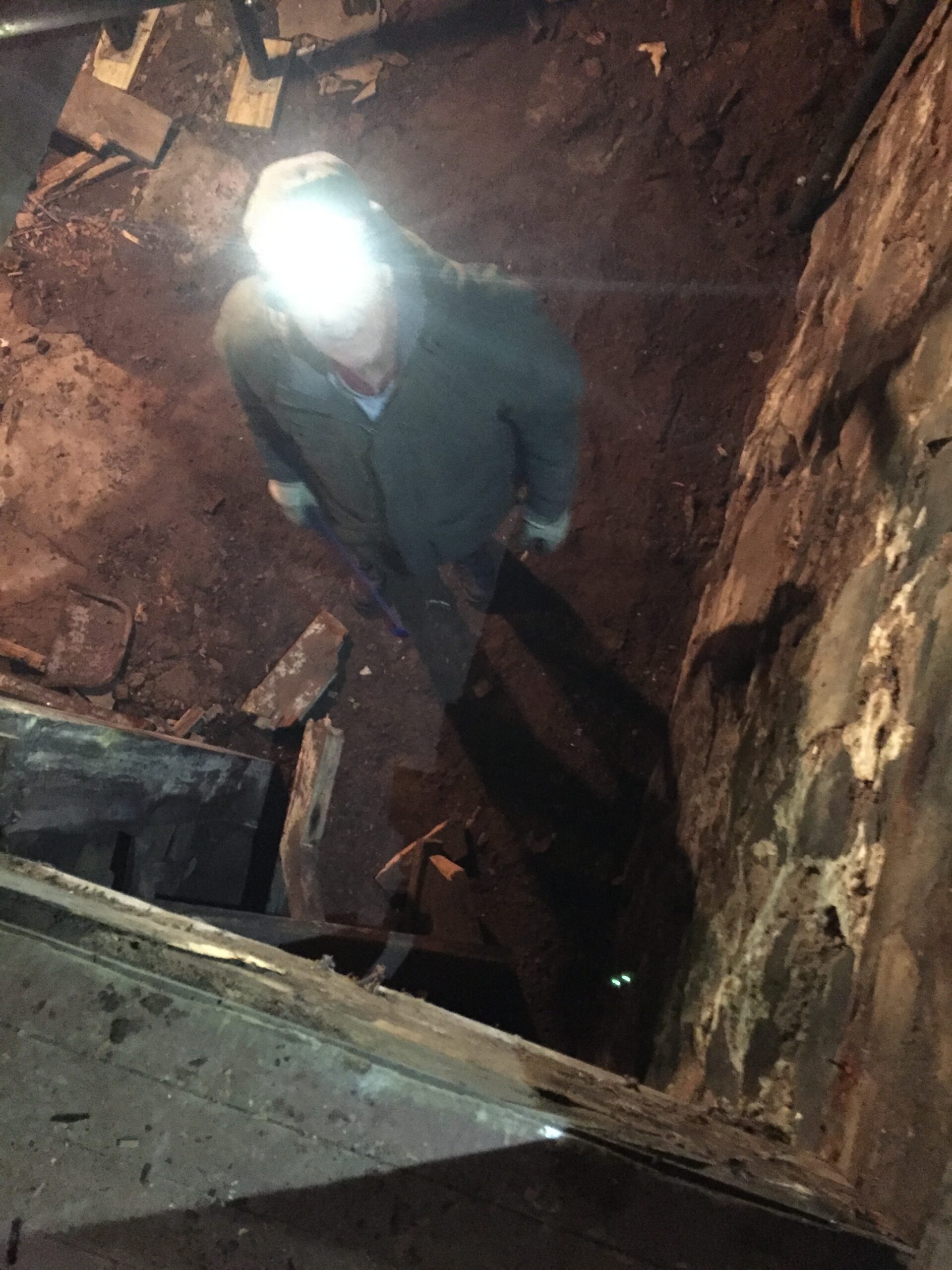 Person with headlamp in dimly lit area