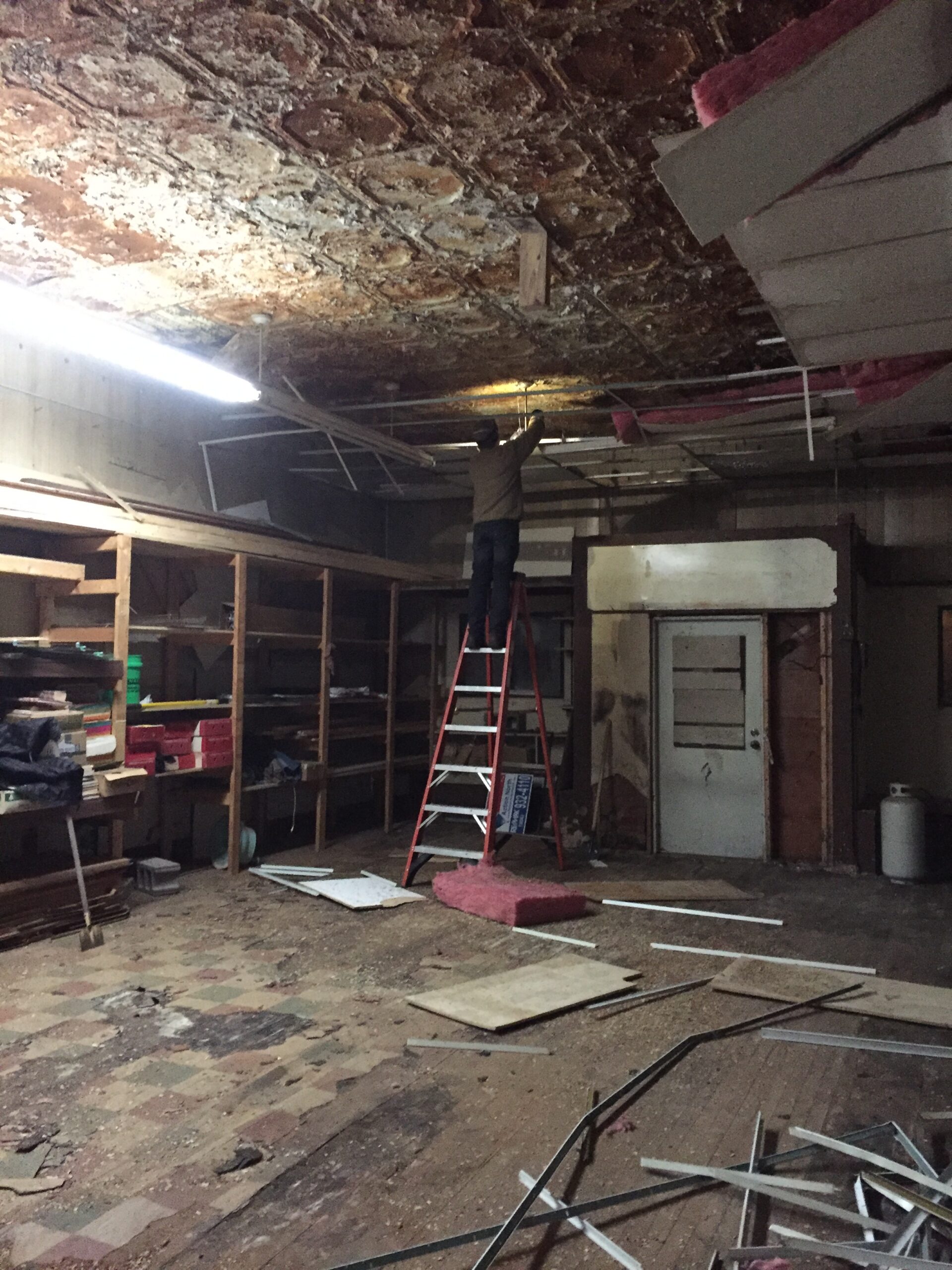 Construction worker fixing ceiling damage