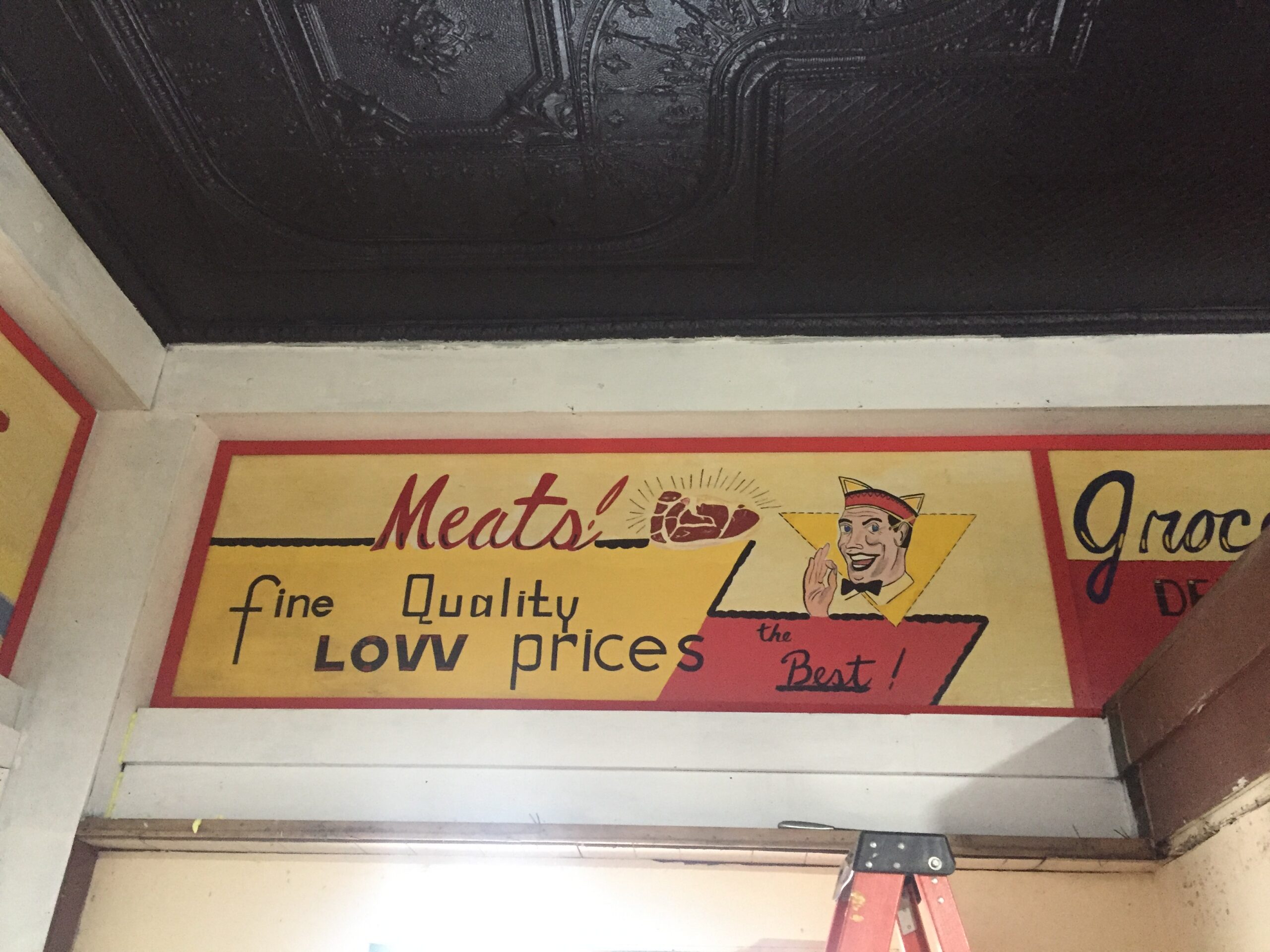 Vintage meat advertisement mural on wall