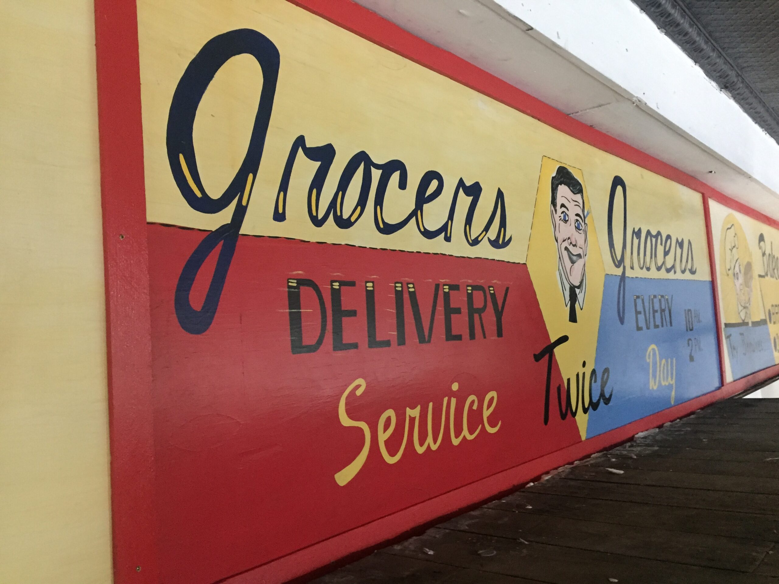 Vintage grocery store delivery sign