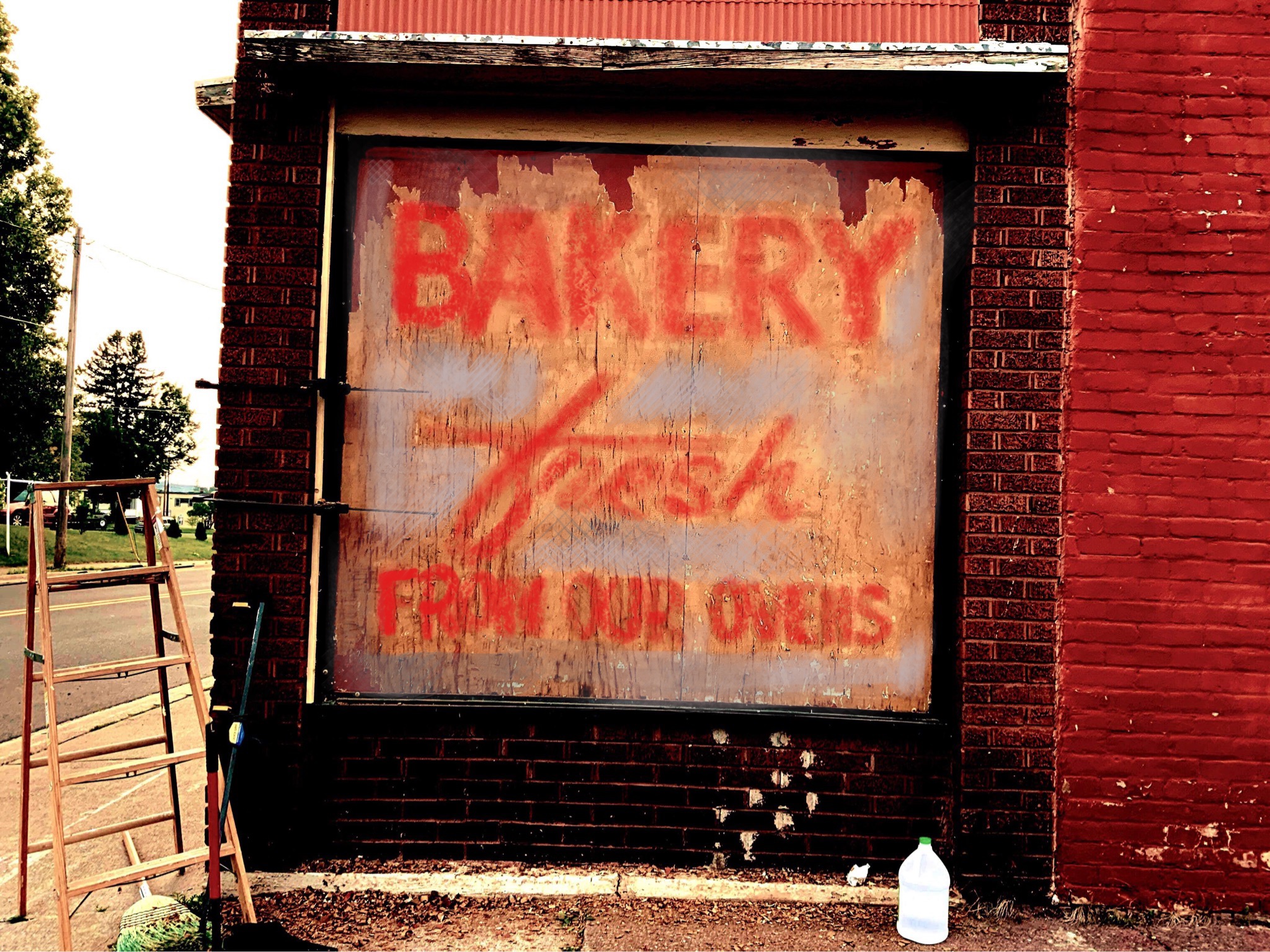 Weathered bakery sign with red lettering
